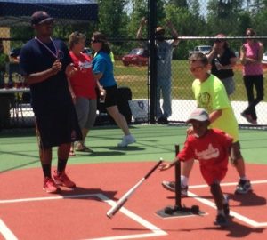 Miracle League player hits the ball